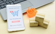 Online shopping / retail ecommerce and delivery service concept : Moblie with shopping app, a credit card on a laptop, depicts consumers purchase or order products from suppliers or digital stores.