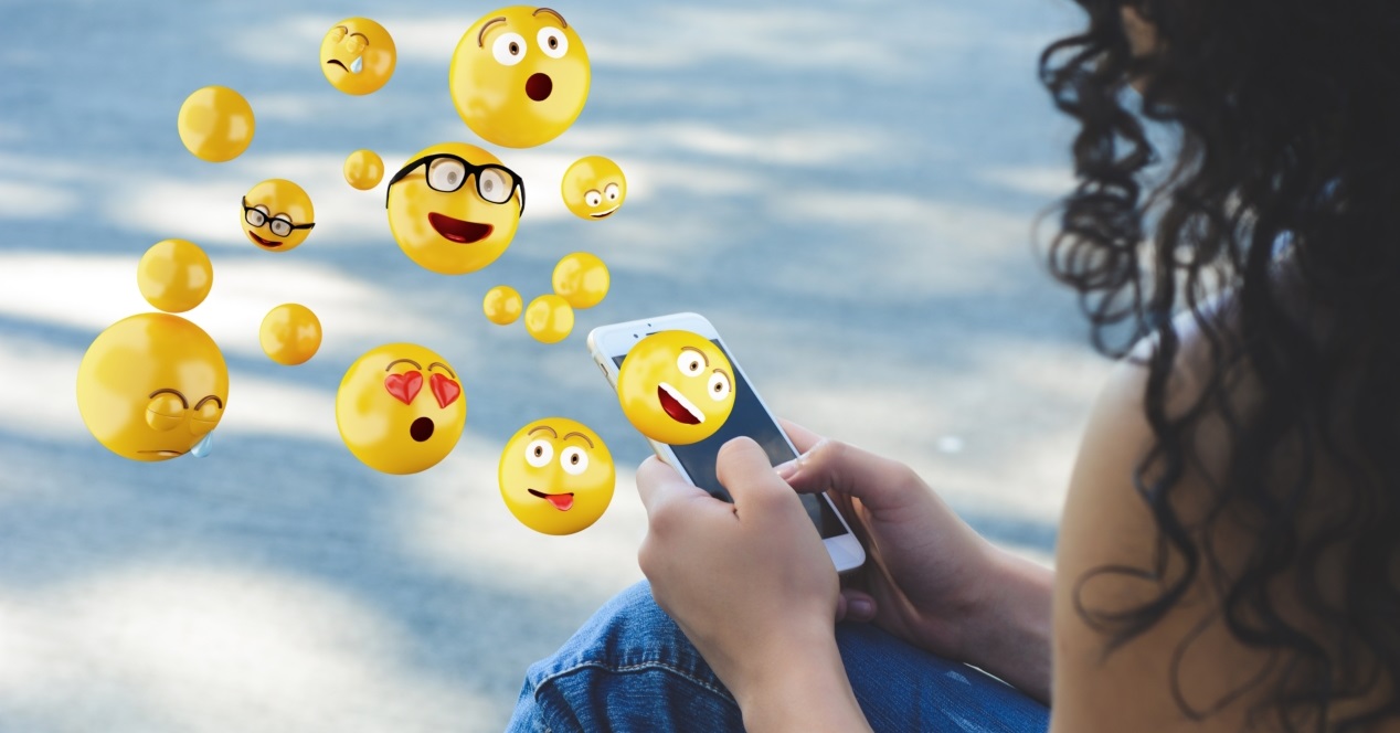 Close Up Of Woman Using Smartphone Sending Emojis. Social Concept.